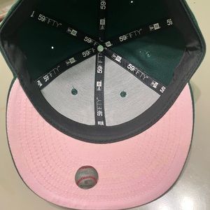 Hatclub In store pickup green Yankees hat pink bottom with heart next to logo.
